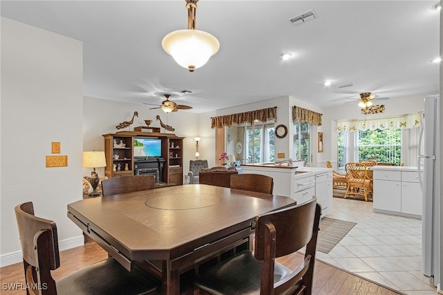 dining area featuring ceiling fan, light hardwood / wood-style floors, and a wealth of natural light