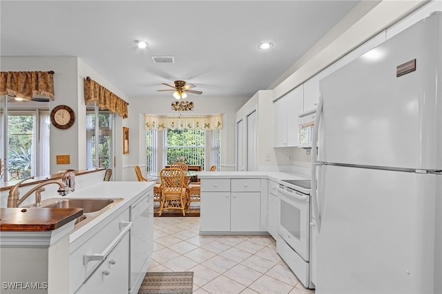 kitchen featuring sink, white appliances, light tile patterned floors, ceiling fan, and white cabinetry