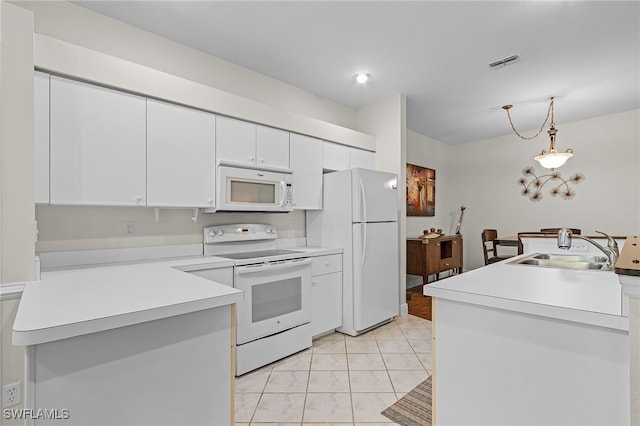 kitchen with sink, decorative light fixtures, light tile patterned floors, white appliances, and white cabinets