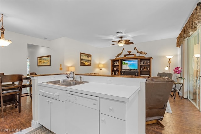 kitchen with sink, light hardwood / wood-style floors, white cabinets, and dishwasher