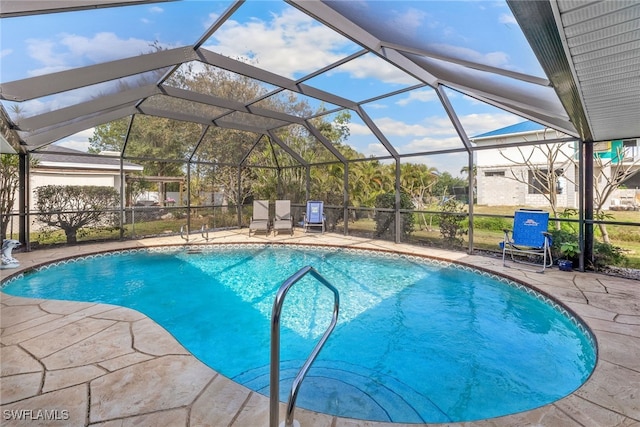 view of pool featuring a patio area and glass enclosure