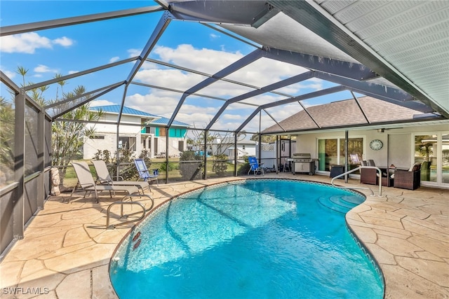 view of swimming pool featuring a grill, a lanai, and a patio