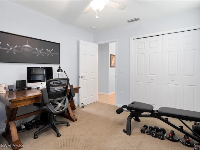 carpeted office space with ceiling fan