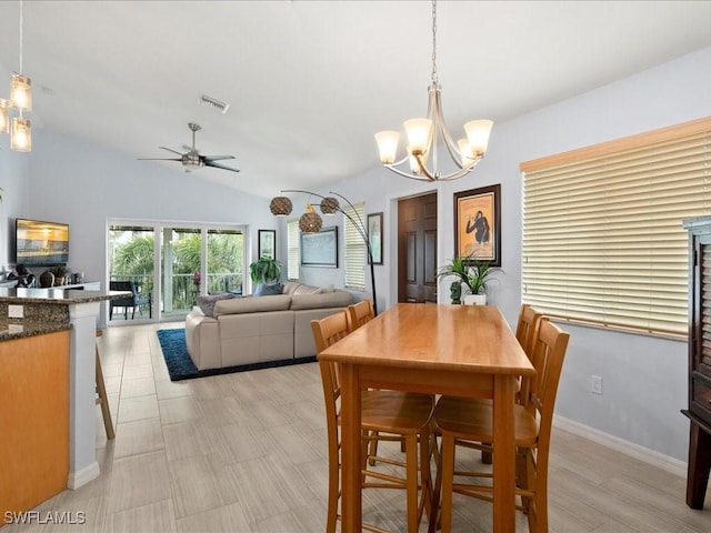 dining space with vaulted ceiling and ceiling fan with notable chandelier