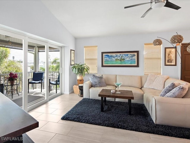 living room featuring vaulted ceiling, light tile patterned floors, and ceiling fan