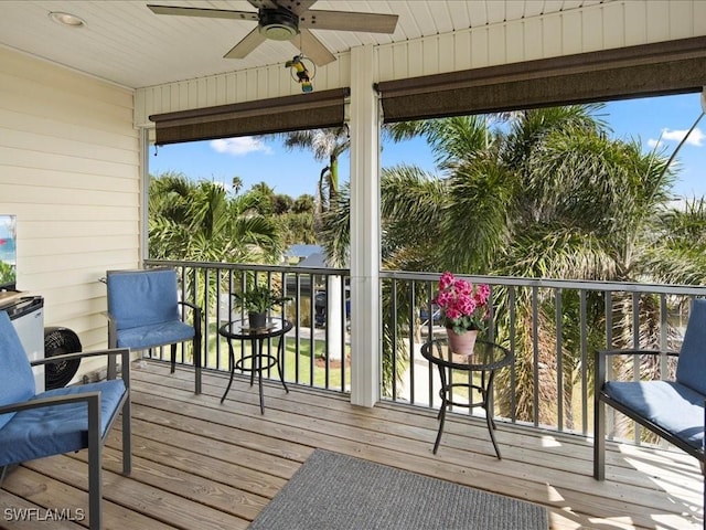 wooden deck featuring ceiling fan