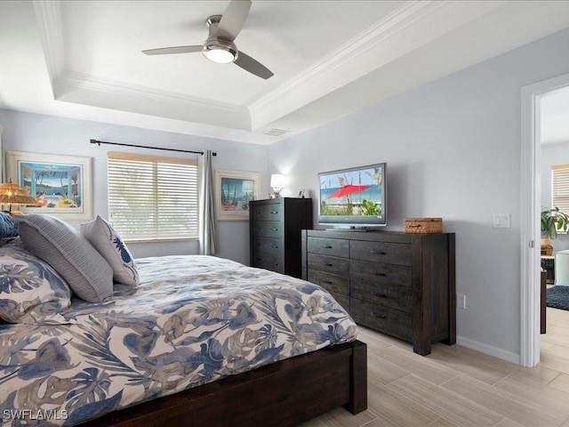 bedroom featuring crown molding, ceiling fan, and a tray ceiling