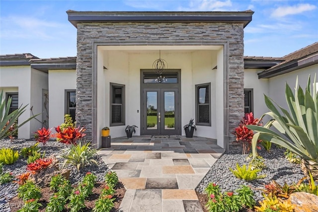 property entrance with a patio and french doors