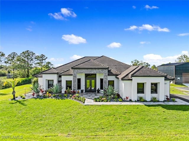 view of front facade featuring a front yard and french doors