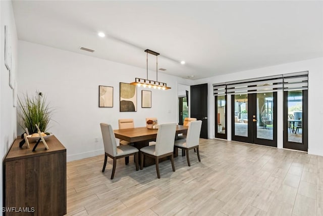 dining space featuring light hardwood / wood-style flooring and french doors