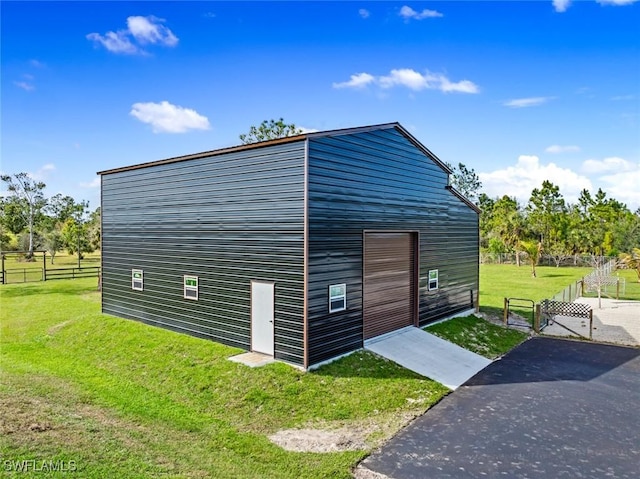 view of outbuilding with a lawn