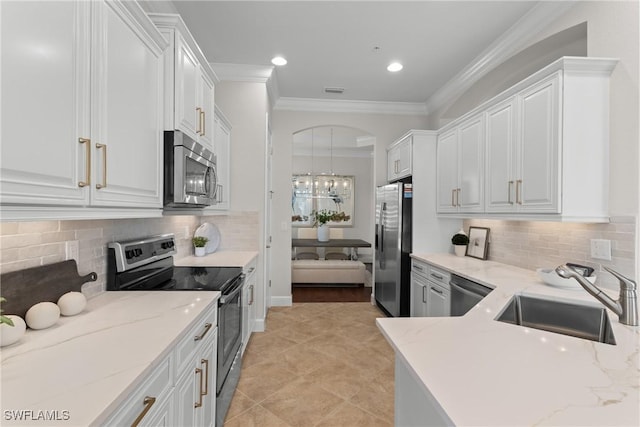 kitchen featuring appliances with stainless steel finishes, sink, white cabinets, and light stone counters