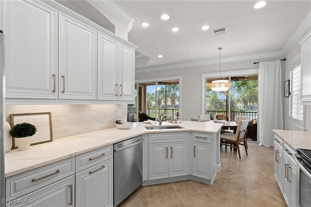 kitchen featuring crown molding, pendant lighting, stainless steel dishwasher, and white cabinets