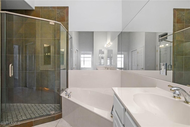 bathroom featuring vanity, a shower stall, a bath, and tile patterned floors