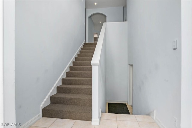 staircase with tile patterned floors