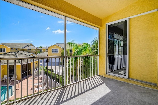 unfurnished sunroom featuring vaulted ceiling and a residential view