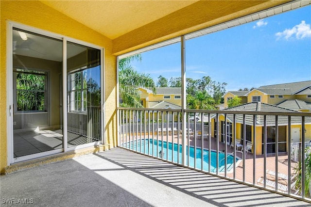 unfurnished sunroom with a residential view and vaulted ceiling