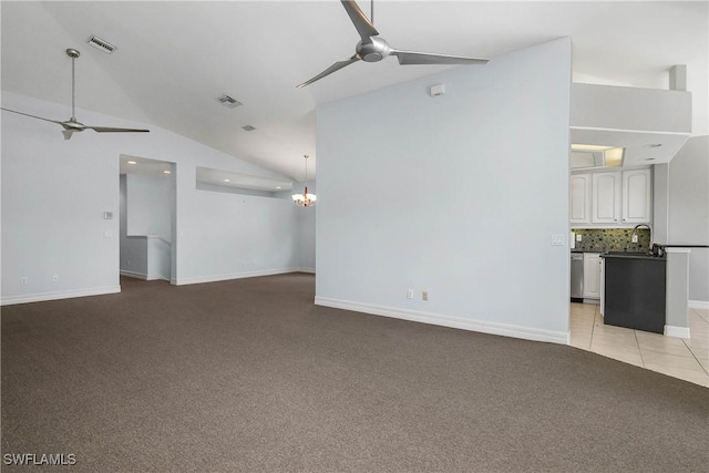 unfurnished living room featuring light colored carpet, visible vents, lofted ceiling, and ceiling fan with notable chandelier