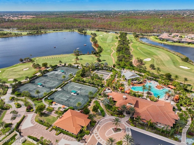 birds eye view of property with a forest view, golf course view, and a water view