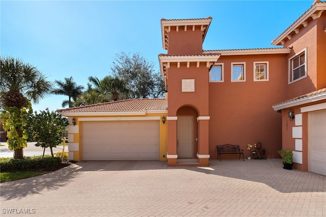 mediterranean / spanish-style house with a garage