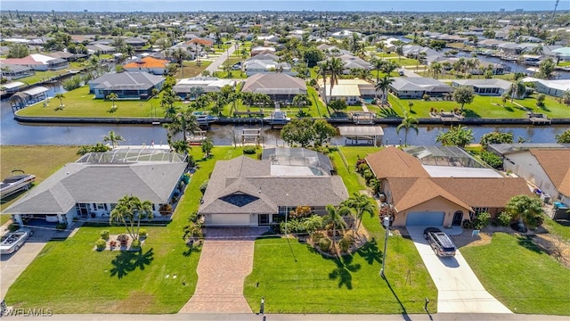 birds eye view of property featuring a water view and a residential view