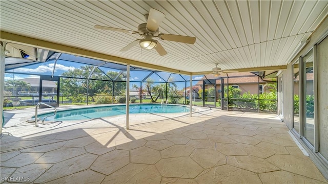 outdoor pool featuring ceiling fan, a patio, and glass enclosure