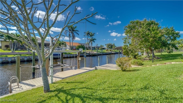 dock area featuring a water view and a lawn