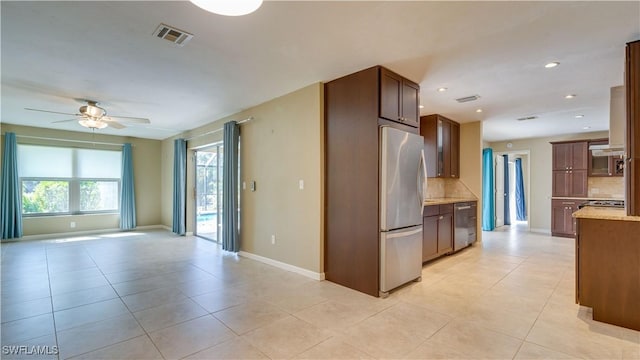 kitchen with light tile patterned floors, visible vents, tasteful backsplash, and appliances with stainless steel finishes