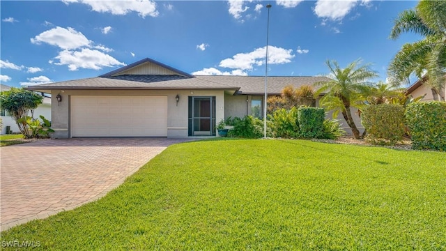 single story home with stucco siding, a front lawn, an attached garage, and decorative driveway