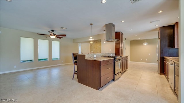 kitchen with a kitchen breakfast bar, appliances with stainless steel finishes, recessed lighting, island exhaust hood, and decorative light fixtures