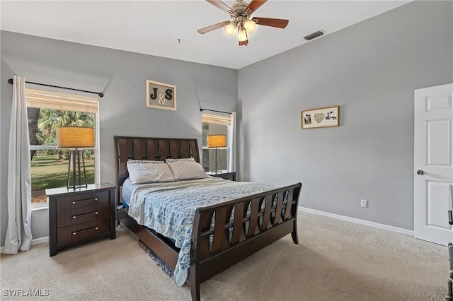 bedroom with light carpet, baseboards, visible vents, and a ceiling fan