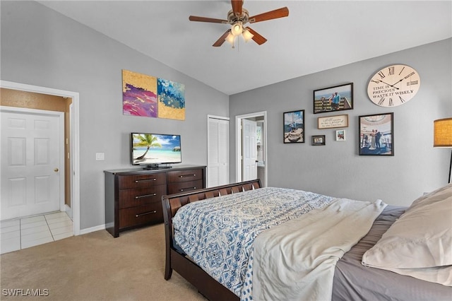 bedroom with light carpet, baseboards, lofted ceiling, ceiling fan, and a closet