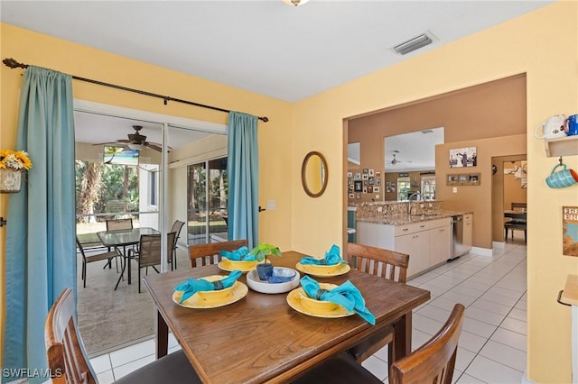 dining space with light tile patterned floors, visible vents, and a ceiling fan