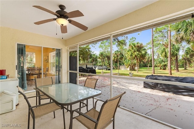 sunroom / solarium with a ceiling fan