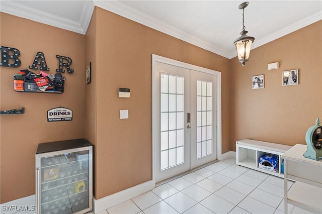 entryway with ornamental molding, wine cooler, french doors, and light tile patterned floors