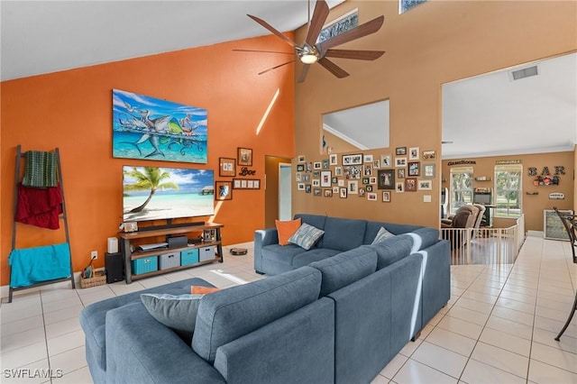 living area with high vaulted ceiling, a ceiling fan, visible vents, and light tile patterned flooring