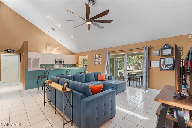 living area featuring light tile patterned flooring, visible vents, high vaulted ceiling, and ceiling fan