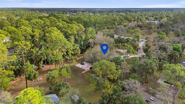 drone / aerial view featuring a forest view