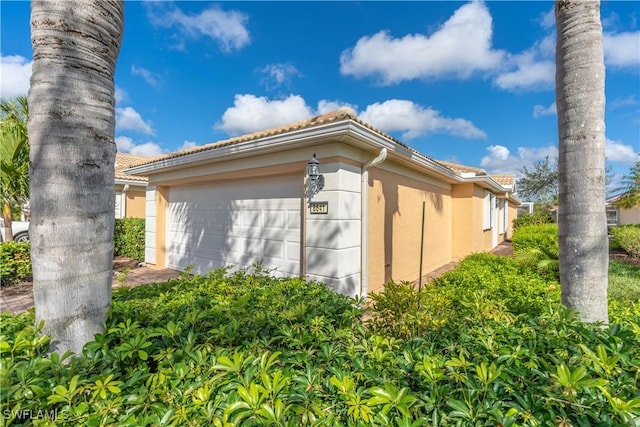 view of side of property featuring a garage