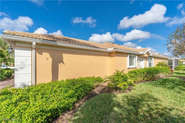 view of property exterior with a yard