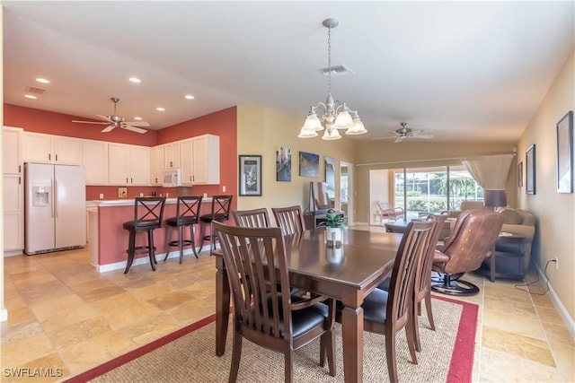 dining space featuring ceiling fan with notable chandelier