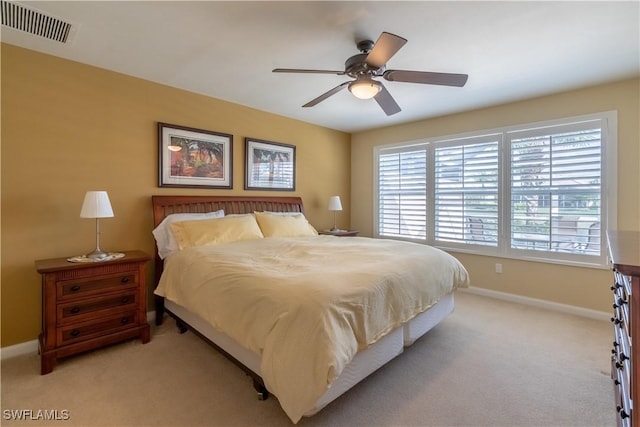 bedroom featuring light colored carpet and ceiling fan