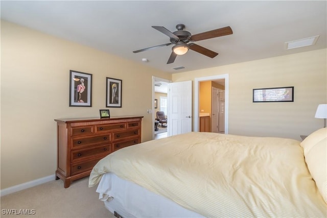 bedroom with ceiling fan, connected bathroom, and carpet