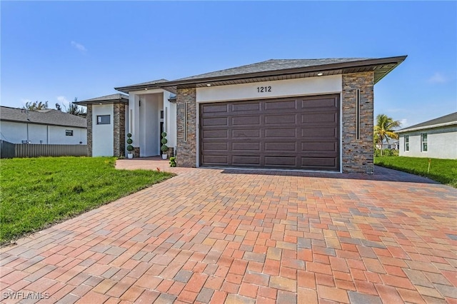 view of front of house with a garage and a front lawn