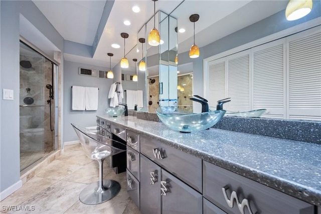 bathroom featuring an enclosed shower, vanity, and toilet