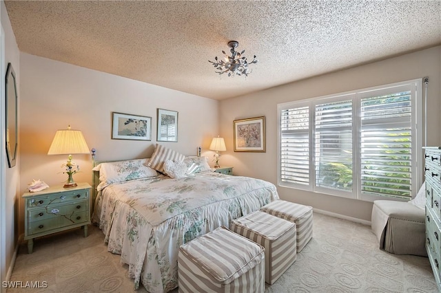 carpeted bedroom featuring a textured ceiling