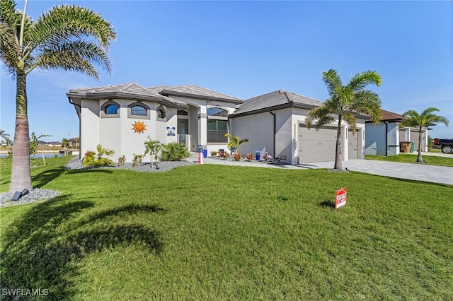 view of front of house with a garage and a front lawn