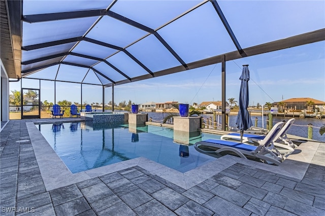 view of swimming pool featuring a patio, a water view, glass enclosure, and an in ground hot tub