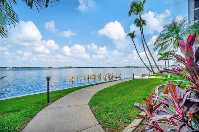 view of community with a water view and a yard