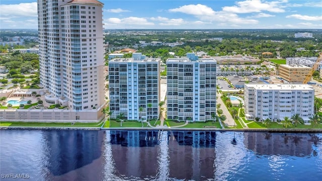 drone / aerial view with a city view and a water view